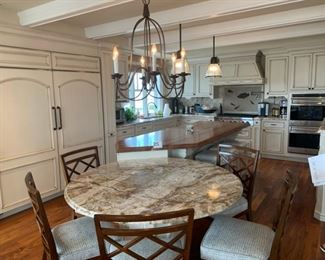 Kitchen table portion of island. Kitchen island overview. Chandelier & pendant lights are for sale. 