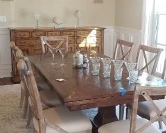 Bausman dining room table is approximately 44" wide x 7' long. Each end extends. With both leaves extended, the table is 10' 6' long