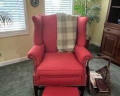 Wingchair and footstool, brass rivets, subtle dotted design, basket magazine rack or log holder, throw