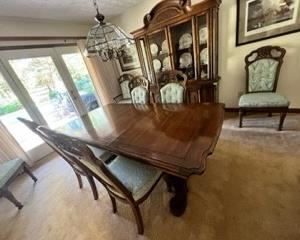Dining room table with gorgeous solid base. 3 leaves (one in for photo). 6 chairs, including 2 captain chairs. Matching China cabinet.