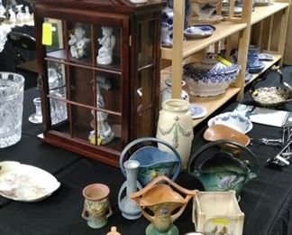 Roseville and Weller pottery. glass door wall shelf.