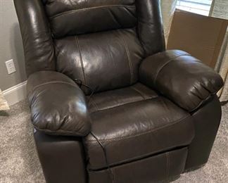 VERY COMFORTABLE LEATHER ROCKING POWER RECLINER. BY ASHLEY FURNITURE.