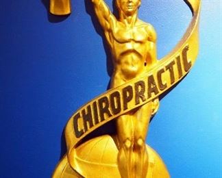 1920s Art Deco Iron Figural Chiropractic Emblem With Globe And Torch, 29" x 14"
