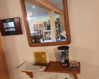 Wooden surround mirror with decorative top, shelf 