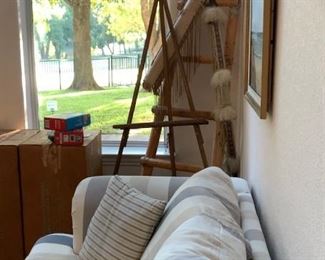 Sofa, easel, KLH speakers, artwork