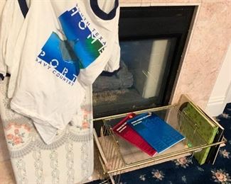 t-shirts, brass and glass bed tray, books
