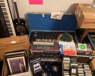 ARP piano/synth, SQ1 keyboard & case, Ensoniq soundboard, Yamaha keyboard, framed vintage sheet music, 8 track cassettes, Yamaha audio recording equipment