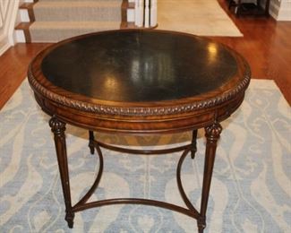 Maitland Smith Round table. The black top has a few scratches on it which could be refinished or polished.