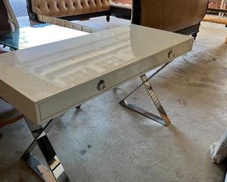 Channing Desk by Jonathan Adler - $1,400 Neo-Classical lines, a dash of Hollywood glamour, and a top note of Mod moxie: that's our Channing Collection. A svelte spin on classic campaign style with a name that says it all: a reference to Margo Channing, Bette Davis's character in All About Eve.
Crisscrossed polished legs and oversized acrylic knobs ooze cinematic glamour, making this an ideal vanity or the perfect spot to pen your next great romance. This is one sleek silhouette—fabulous for a small space.