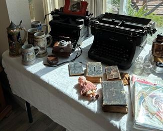 Antique type writers, antique bibles/hymnal , kewpie doll,  vintage jack and hill books, German beer steins,  Kodachrome camera 