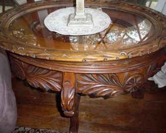 Antique oval hand carved glass topped table