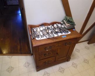 That hand carved cabinet and  silver plate serving pieces
