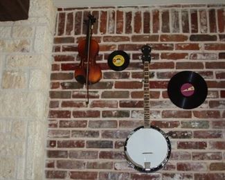 Rogue steel string guitar, Rogue mandolin, Irin banjo, electric cigar box guitar and a violin.  