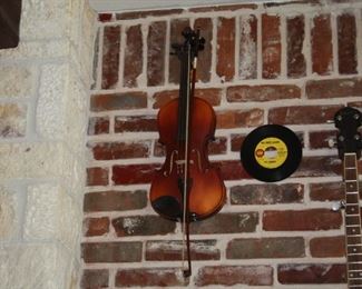 Rogue steel string guitar, Rogue mandolin, Irin banjo, electric cigar box guitar and a violin.  