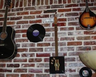 Rogue steel string guitar, Rogue mandolin, Irin banjo, electric cigar box guitar and a violin.  