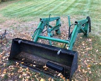 John Deere 70A front end loader with added hooks on bucket.   1st attachment  