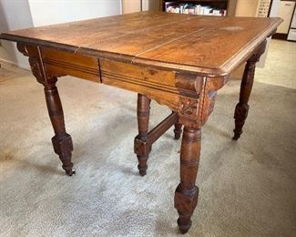 Bought in Iowa 1860s.  This 19th century Eastlake style Farm House table has the Rare &   Wonderful original finish with all 8 original leaves.  Made from Solid & clear popular wood & pinewood.  Original caster.    A fine example of farmhouse Victorian furniture!