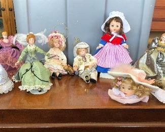 $3.00 for all 9 Porcelain dolls/ornament . 3 dolls are on Kaiser stands. Large doll (Belgium) eyes open and close. Doll heads with hats are ornaments. Both have small marks on face. 