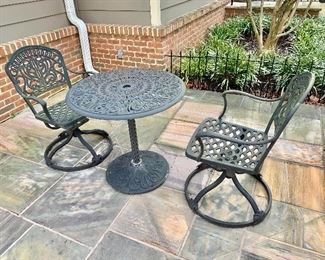 Metal cafe table with swivel chairs