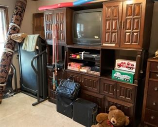 Treadmill in corner, wall unit with storage 