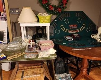 Upstairs - table with game cover, lamp shades, wreath, miscellaneous 