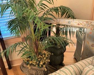 Artificial plant in an elephant planter; large mirror