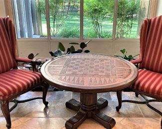 Two red/orange arm chairs; study base and beautifully tooled top game table