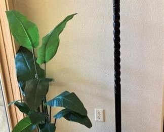 One of several artificial plants; hat stand