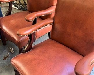 Orange leather arm chairs