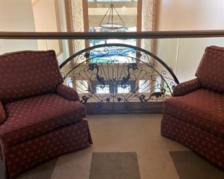 Matching occasional chairs (red and gold fabric) ; arched wall/above-the-door décor