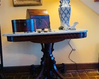 Antique marble top entrance table and notice the wooden early boxes and the beautiful blue and white lamp