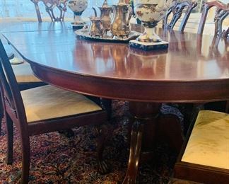 Pedestal dining table with paw feet and six Chippendale chairs. Table comes with table pads and even more leaves than photoed. 