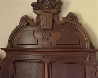 Antique walnut queen size bed from France…yes it is a French Victorian bed.
Stylization of pediment to resemble a flower basket.