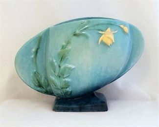 Many pieces of Roseville pottery.