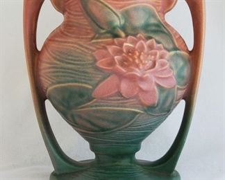 Many pieces of Roseville pottery.