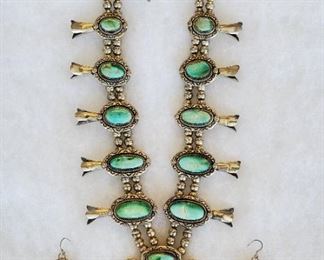 28" long Navajo turquoise and sterling silver squash blossom necklace, signed V&N (Vincent & Nita) Edsitty, and matching pierced earrings. The necklace contains 18 stones. The naja is 3 1/2" wide and 3" long. The earrings are 1" long and 1/2" wide. The turquoise appears to be Royston, but please make up your own mind after reviewing the photos.
