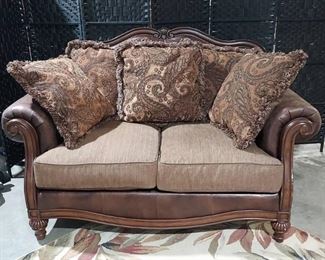 Nice Traditional Oversized Rolled Arm Loveseat from Ashley Furniture includes throw pillows