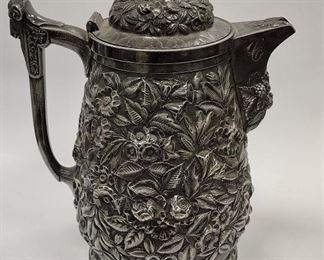 VICTORIAN QUADRUPLE PLATE HIGH RELIEF REPOUSSE' WATER PITCHER WITH ENAMELED METAL LINING FOR INSULATION. MON