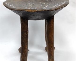  EAST AFRICAN KAMBA STOOL. CIRCULAR WITH FOUR LEGS, DISH SEAT SET WITH BEADS. APPEARS CARVED FROM ONE BLOCK OF WOOD. 13.5" TALL