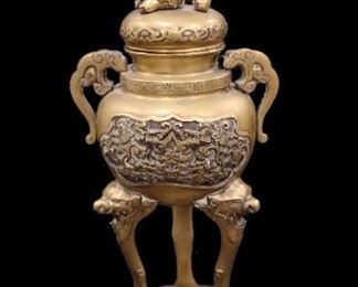 CHINESE BRASS BURNER OR URN: 12.5" TALL. DECORATED BASE WITH BATS, LION FACES ON THE SIDES AND A FOO DOG FINIAL. FINIAL IS HOLLOW ALLOWING USE FOR INCENSE