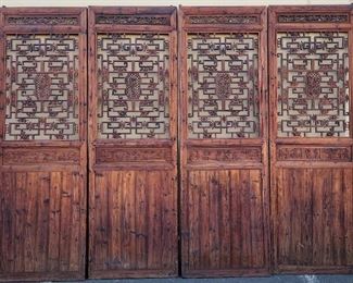 SET OF FOUR LARGE CHINESE TEMPLE DOORS/DIVIDERS. 9' 6 1/4" TALL BY 3' 1 3/4" WIDE. CARVED COURT YARD SCENES ONE EACH AND DIFFERENT FIGURES ON EACH SCREEN AREA