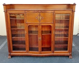 2nd QUARTER 20TH CENTURY LARGE GLASS DOOR BOOKCASE/DISPLAY CASE. DECORATED WITH APPLIED BEAD TRIM, FLUTED COLUMNS AND PAW FEET. 6'2.5" WIDE, 5'2.5" TALL, 18.5" DEEP