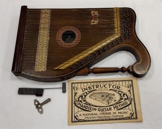 OSCAR SCHMIDT MANDOLIN GUITAR ZITHER. INCLUDES TWO FINGER PICKS, TUNING WRENCH AND MUSIC THAT ARE PLACED UNDER THE STRINGS. 21" X 13"