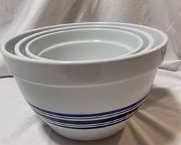 Three Large Nesting Mixing Bowls (Set of 3) (
These versatile bowls earn their stripes in the kitchen, providing cool style for every task from beating eggs and prepping cake batter to tossing salad and serving pasta. Crafted of scratch-resistant stoneware, each bowl blue stripes across the middle. The set of three nests for compact storage. 
Set of three includes one of each size.
Bowls nest for compact storage.
No chips or scratches.
Microwavable and dishwasher safe.
Sizes
Small: 7" diam., 4.5" high; 2 1/2-qt. cap
Medium: 8" diam., 5 1/4" high; 2 3/4-qt. cap.
Large: 9 1/2" diam., 6 " high; 5-qt. cap.

