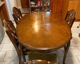Mid-Century Dining Room Set        ($50)
Configuration:  Dining Table & Chair
Number of Seats:   5
This vintage dining room set served six generations of Italians who loved to eat! The table and chairs are unbelievably sturdy. The finish, however, shows wear with its water stains and dings. This is not made of solid wood - it's something much denser and heavier.
Measurements:
58" long and 42" wide. 
12" leaf. 
5 chairs (one with arms)