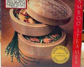 Bamboo Steamer ($15 )
A fun way to cook healthy – and fast!
Everyone needs a wok in their kitchen!
While it is mainly used for stir-frying, you can use your wok to braise, stew, steam, deep-fry, or smoke.
This wok cooks quickly, and enables you to stir-fry food with less oil. The curved and round shape cooks food with less oil. It’s so big, it got a larger capacity to cook food compared to most frying pans.
The accompanying bamboo steamer cooks food with no fats or oils. – plus it’s easy to clean! 
While the Wok has been used, the Bamboo Steamer has not. 