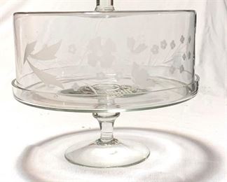 XL Glass Covered Cake Stand
($20 )
This is a large yet surprisingly delicate cake stand perfect for storing and displaying cakes, hors d’oeuvres, muffins and more. Stand features an elegant footed base and is topped by a glass dome. Skilled artisans hand etched a lovely floral design on the front of the cover. There are slight chips along the bottom edge where the cover meets the stand - the imperfections aren't visible due to the lip. 
