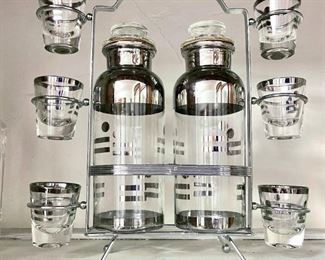 Art Deco Vintage Liquor Decanters with Caddy / Six Matching Shot Glasses
$250  · In stock
Listed 27 weeks ago in Boston, MA
Details

    Condition
    Used - like new
    Material
    Glass
    Color
    clear

Alcohol never looked so good! 

This beautiful Vintage Decanter Set has a unique chrome design on the bottles and 6 matching shot glasses in a custom caddy holder. The decanters have glass tops accompanied by metal tags for Vodka, Gin, Scotch, Bourbon, Cognac, and Sherry. This sleek modern art deco? bar set is in excellent condition.