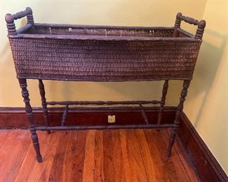 Antique 1900s Victorian Wicker Plant Stand Planter With Liner
$100

Lovely rare vintage woven wicker rattan plant stand with a removable galvanized liner. In incredibly good antique condition, the plant stand has structurally withstood the test of time. There is some wear in the rattan, but this plant stand was designed to hold potted plants inside while the liner catches runoff. 

Traditional post legs provide excellent stability and support.  Planter is perfect inside or on a covered porch but has myriad versatile uses.

30" Long
10" Wide
31" Tall

