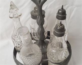 Pewter condiments stand with lidded decanters 
